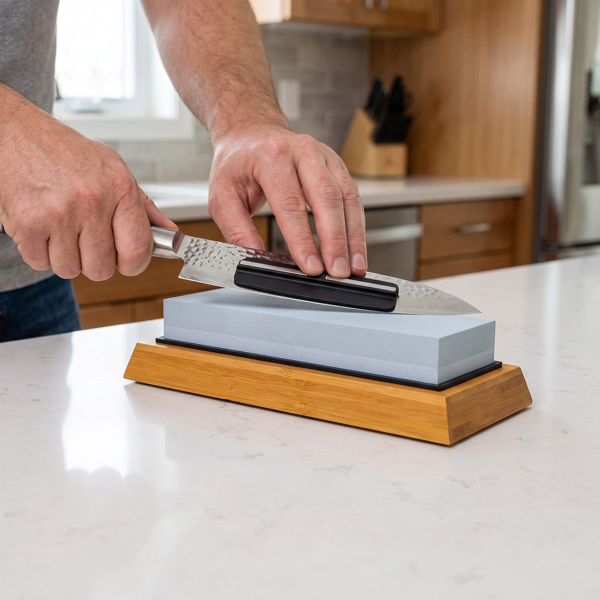 1000/6000 Grit Whetstone Knife Sharpener with Angle Guide in use, sharpening a chef's knife with the angle guide attached