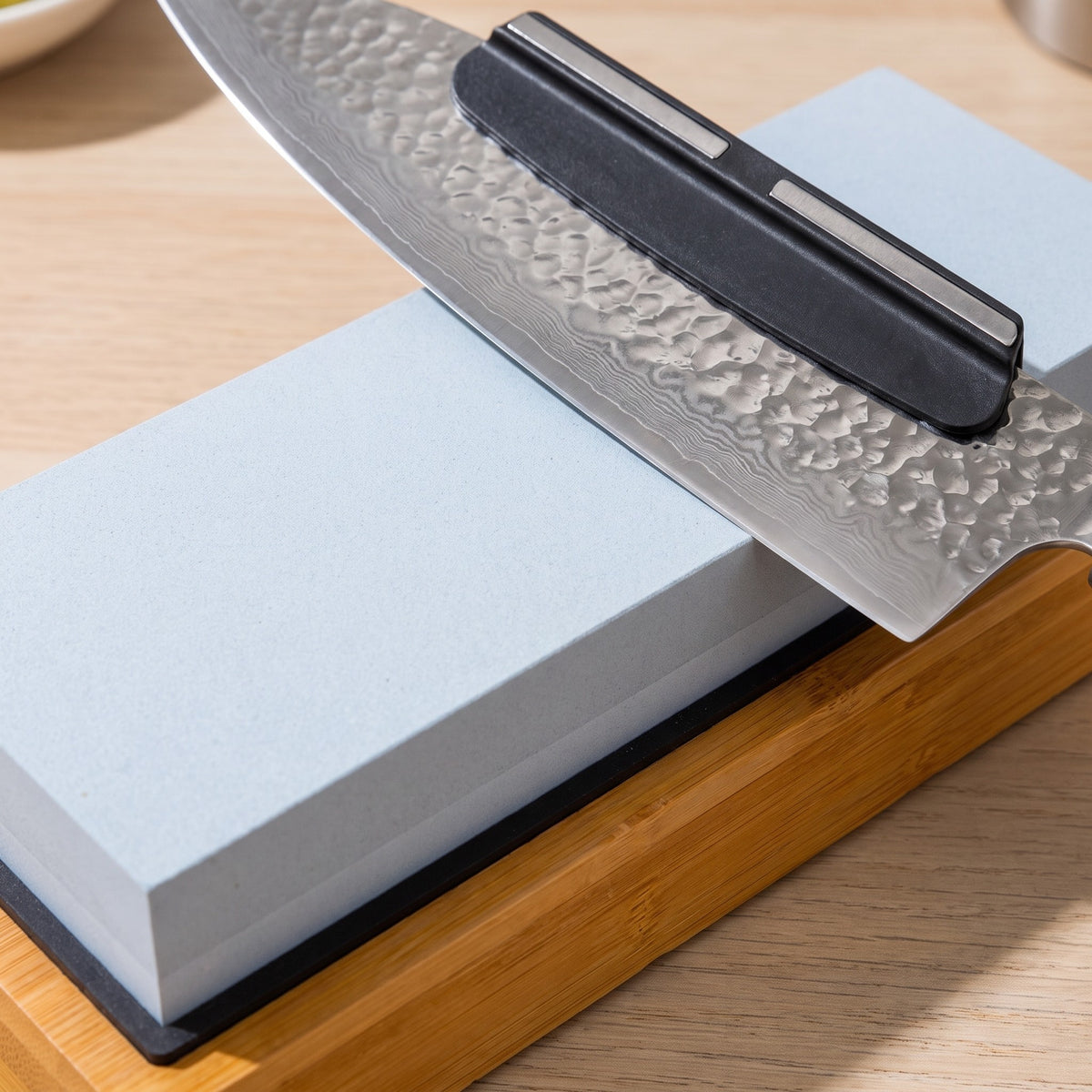 1000/6000 Grit Whetstone Knife Sharpener with Angle Guide - close-up of the corundum stone and silicone angle guide