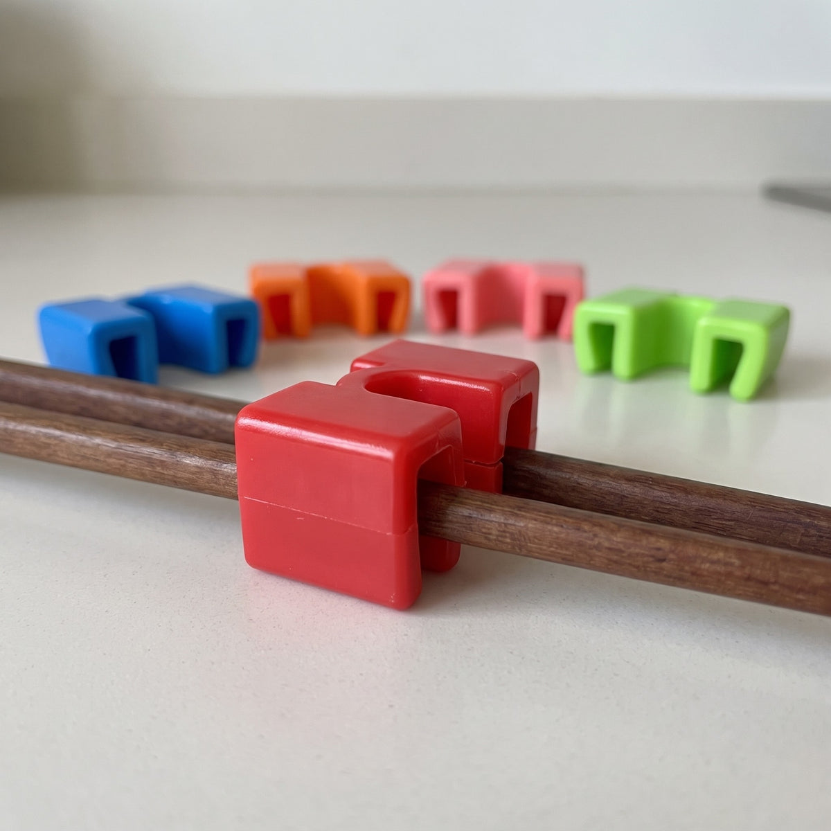 5-Pack Adjustable Chopstick Training Helpers for Kids and Beginners - close-up of a helper clipped onto chopsticks