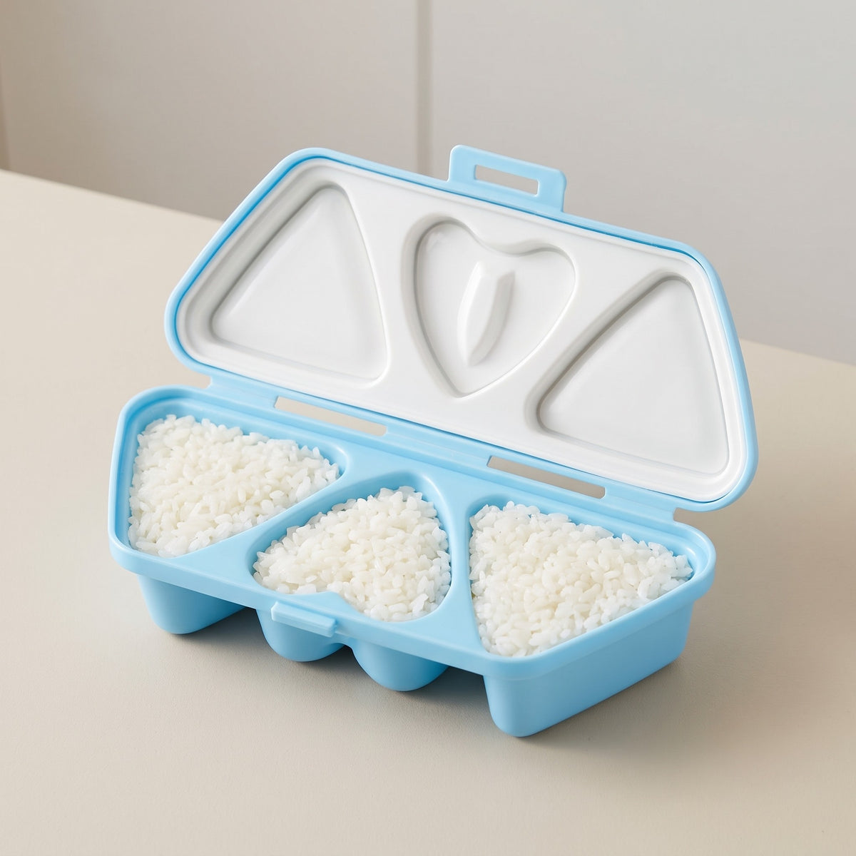 6-Compartment Triangle and Heart Onigiri Rice Ball Mold - close-up of the smooth plastic triangle and heart compartments
