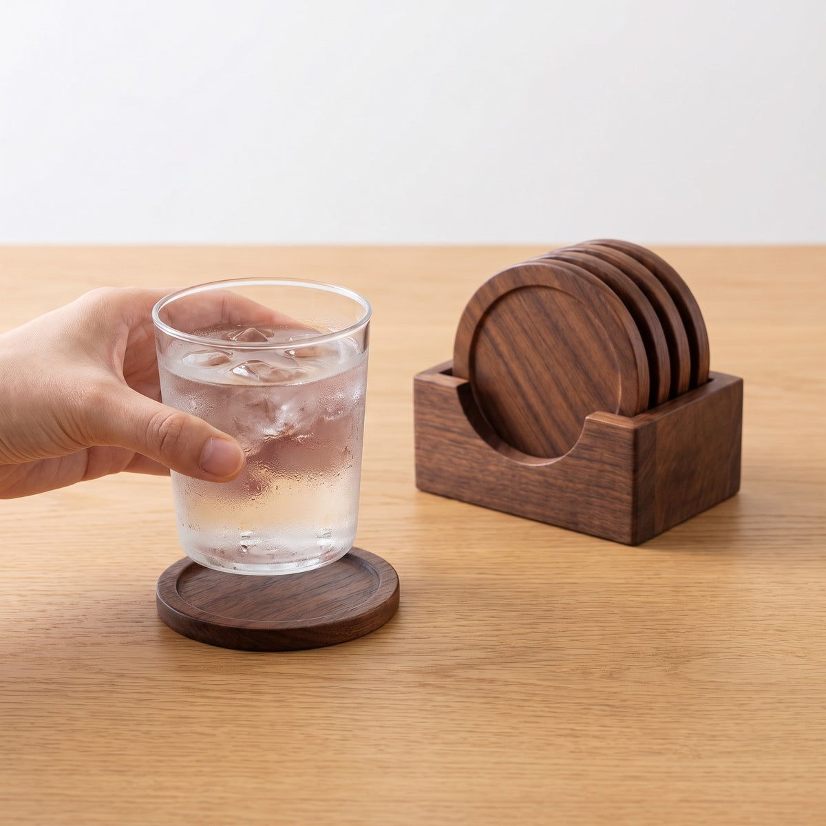 6-Piece Wooden Coaster Set with Holder and Raised Rim in use, setting a glass of iced water on a coaster
