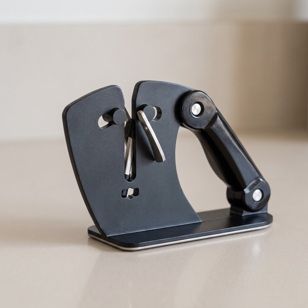 Adjustable Angle Knife Sharpener with 22 to 46 Degree Range - close-up of the crossed sharpening rods and angle arm