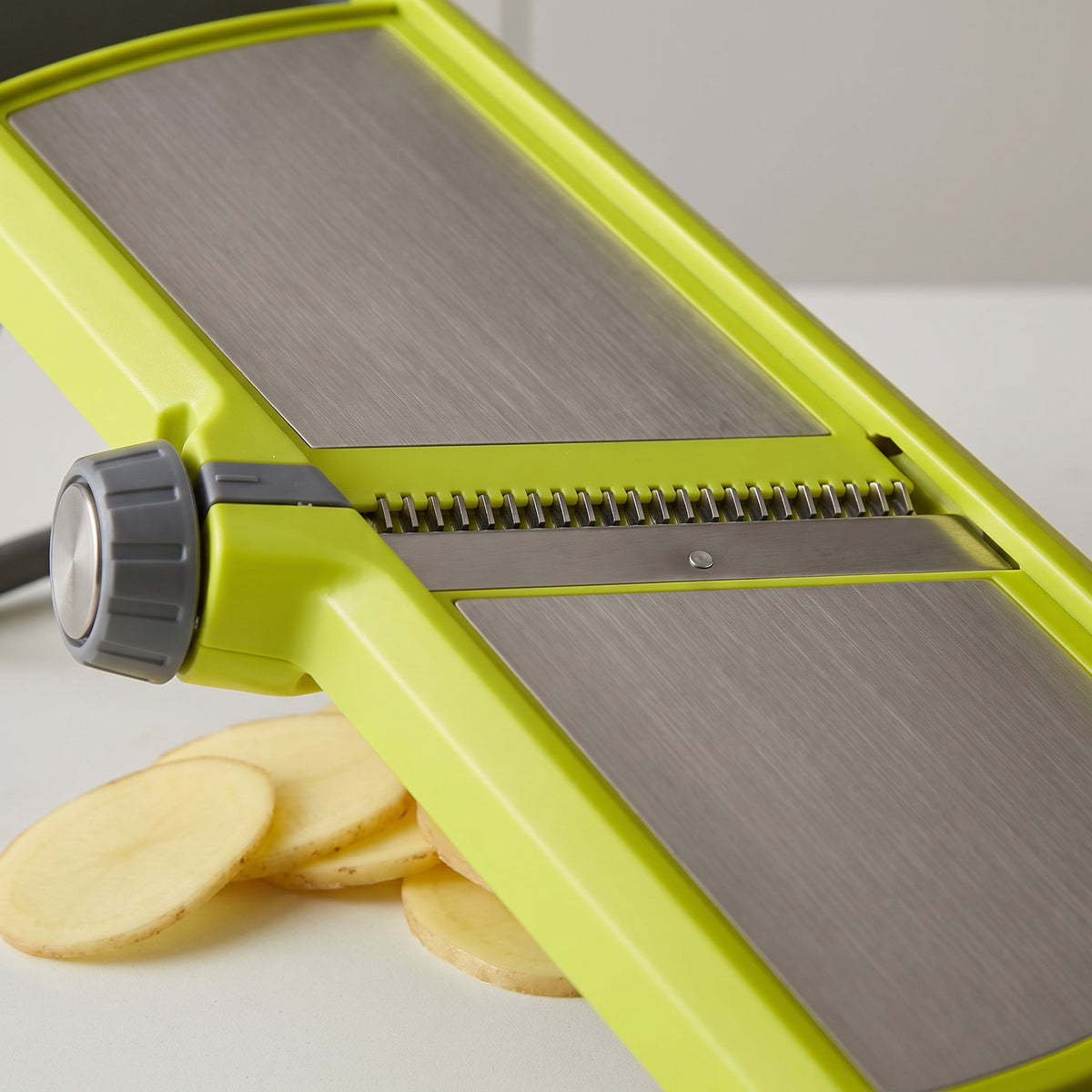 Adjustable Mandoline Slicer with Hand Guard and Non-Slip Base - close-up of the stainless steel blade, julienne teeth and side lever