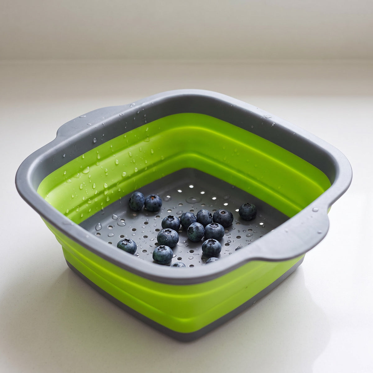 Collapsible Silicone Colander with Rigid Rim - close-up of the food-grade silicone folds, rigid rim and drainage holes