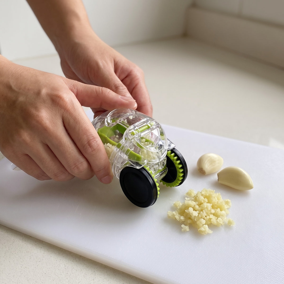 Compact Rolling Garlic Press for Ginger and Shallots in use, rolling garlic cloves on a cutting board
