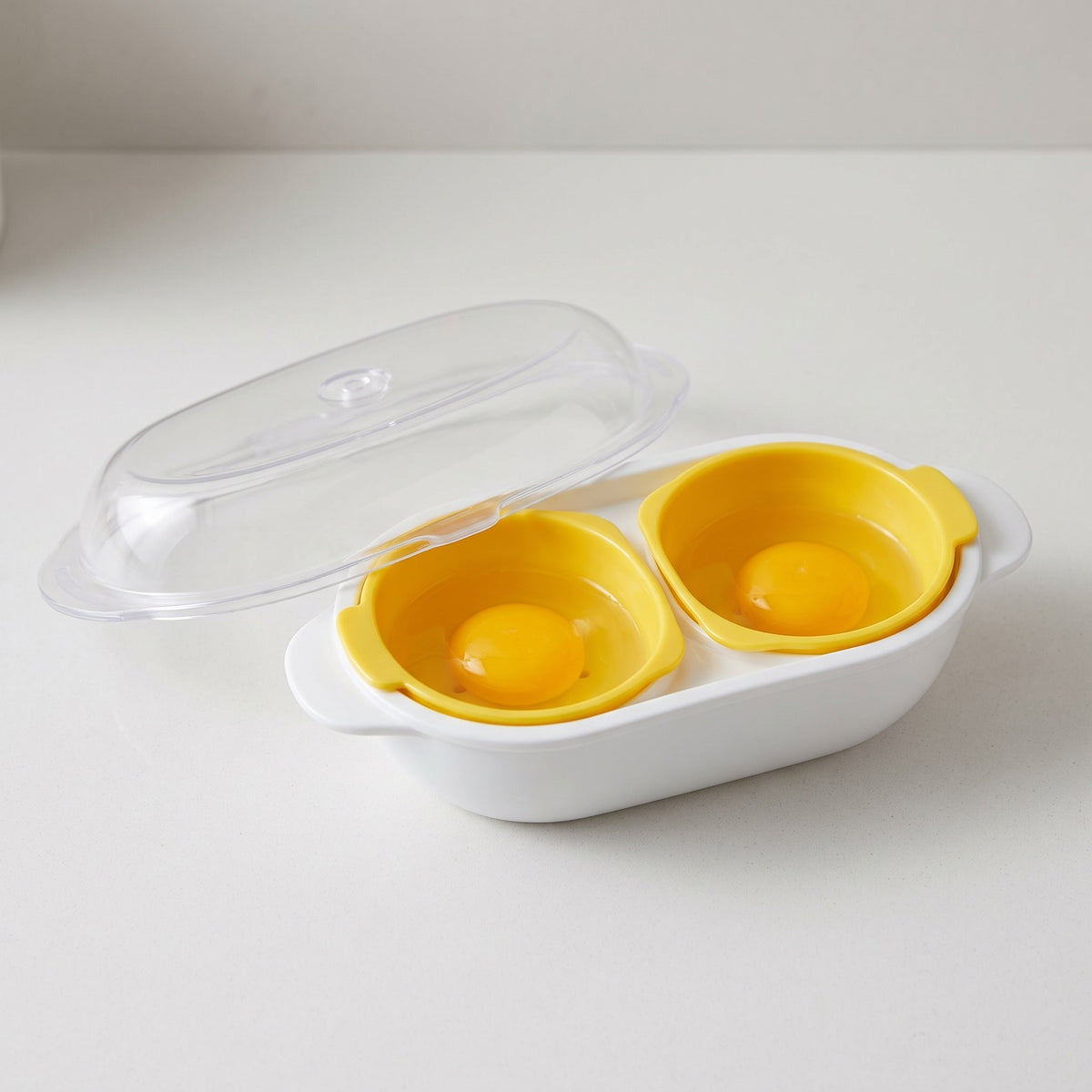 Double-Cup Microwave Egg Poacher with Steam-Release Lid - close-up of the two egg cups and steam-release lid