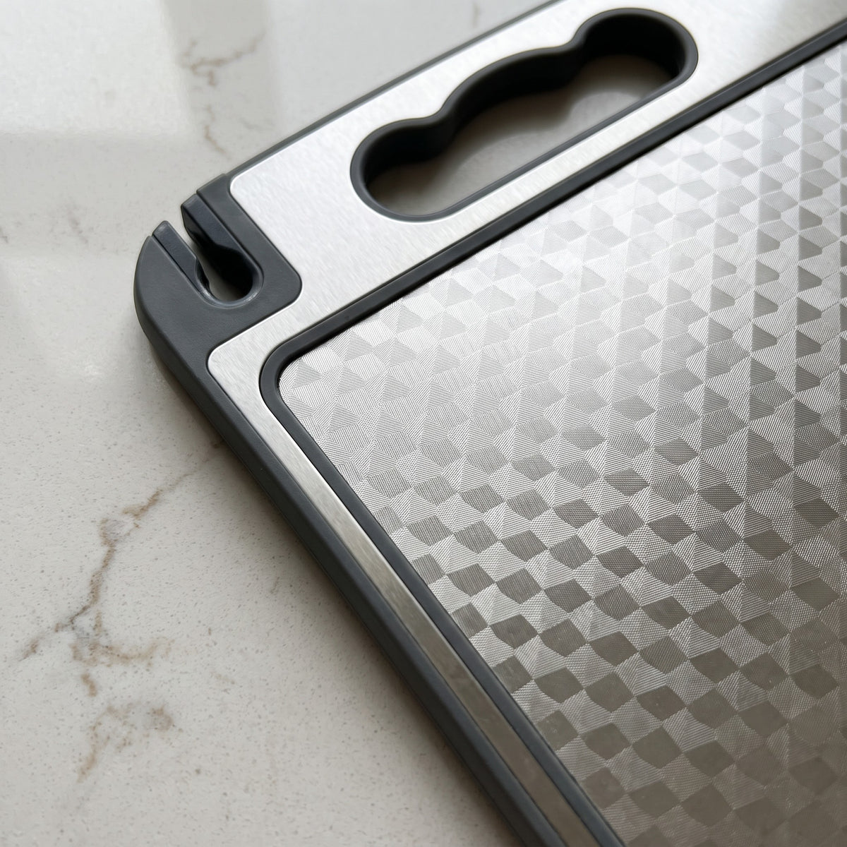 Double-Sided Plastic Cutting Board with Knife Sharpener - close-up of the built-in knife sharpener and juice groove