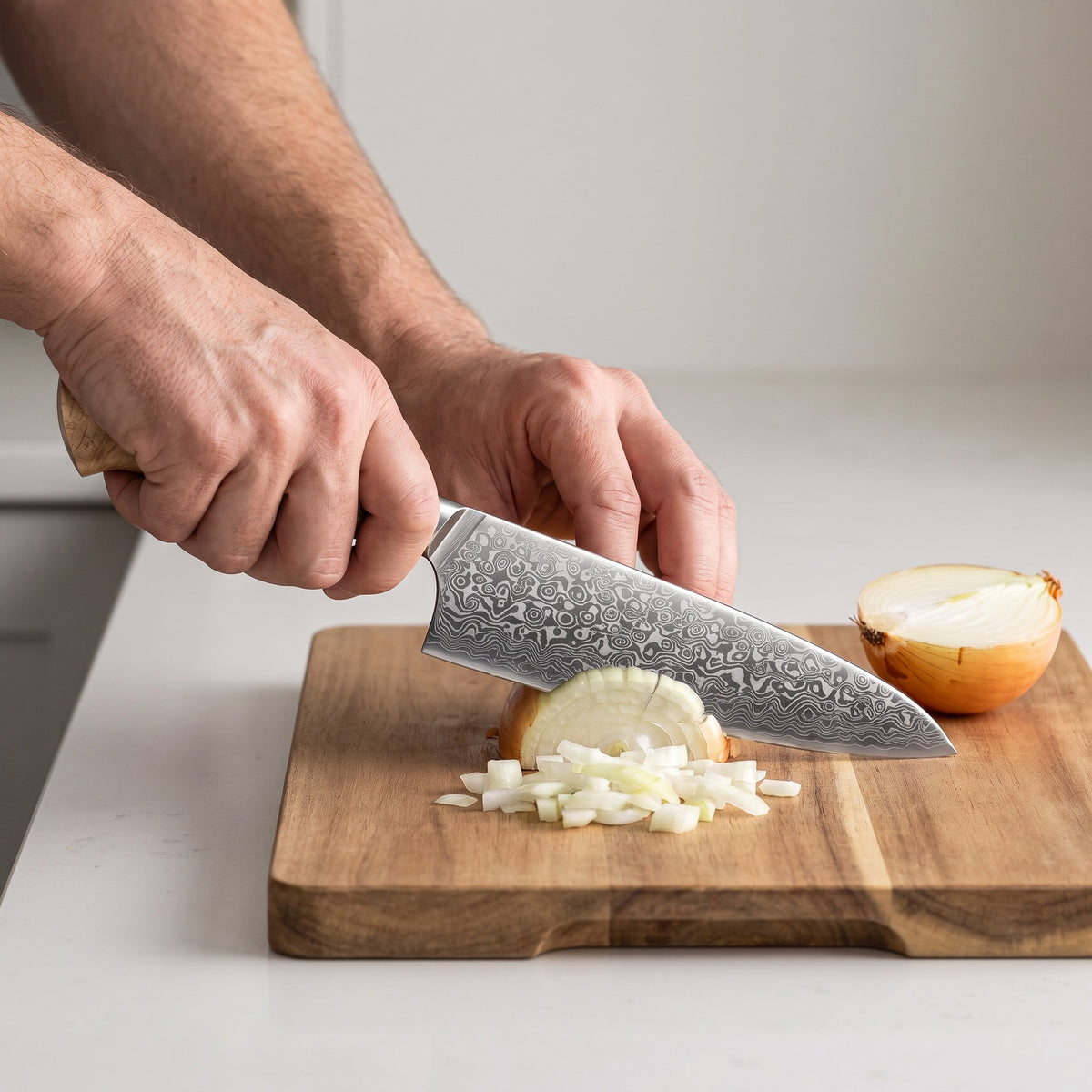 Folded Damascus Steel Knife Set with Wood Handles in use, dicing an onion