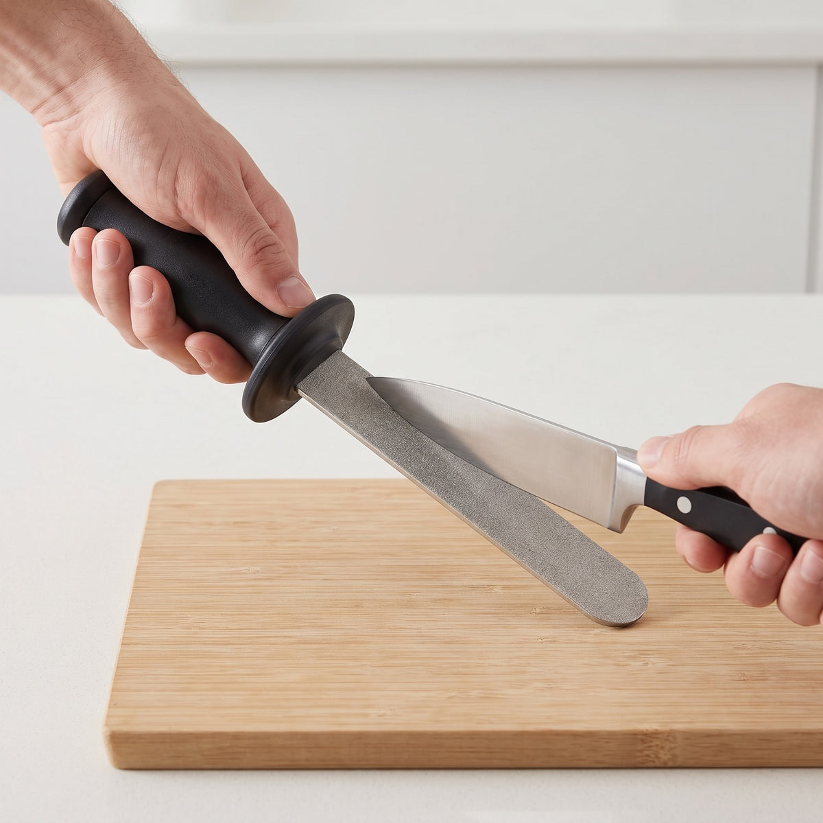 Handheld Diamond Knife Sharpener for Steel and Ceramic Knives in use, drawing a chef knife across the diamond surface