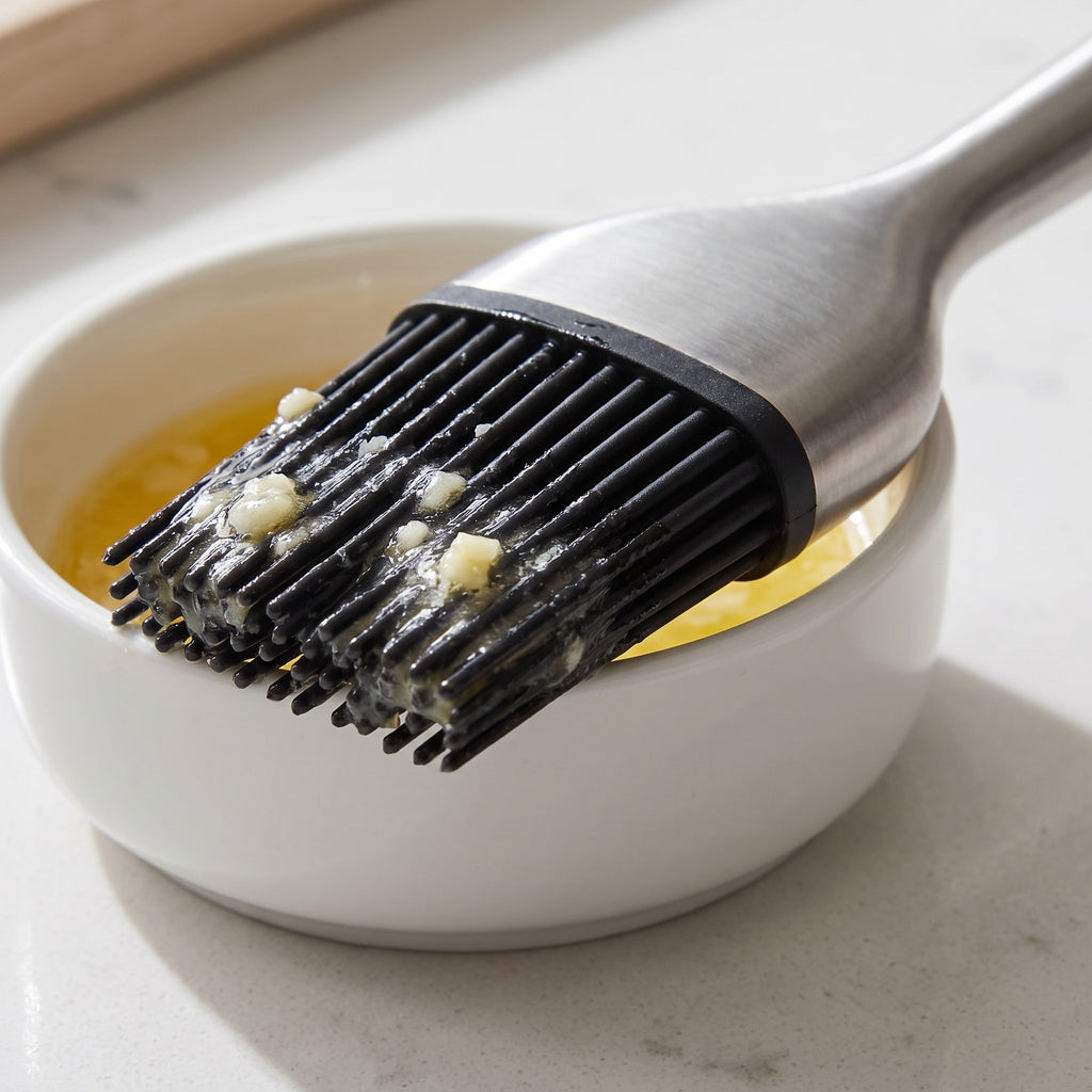 Heat-Resistant Silicone Basting Brush with Replaceable Head - close-up of the silicone bristles coated in garlic butter