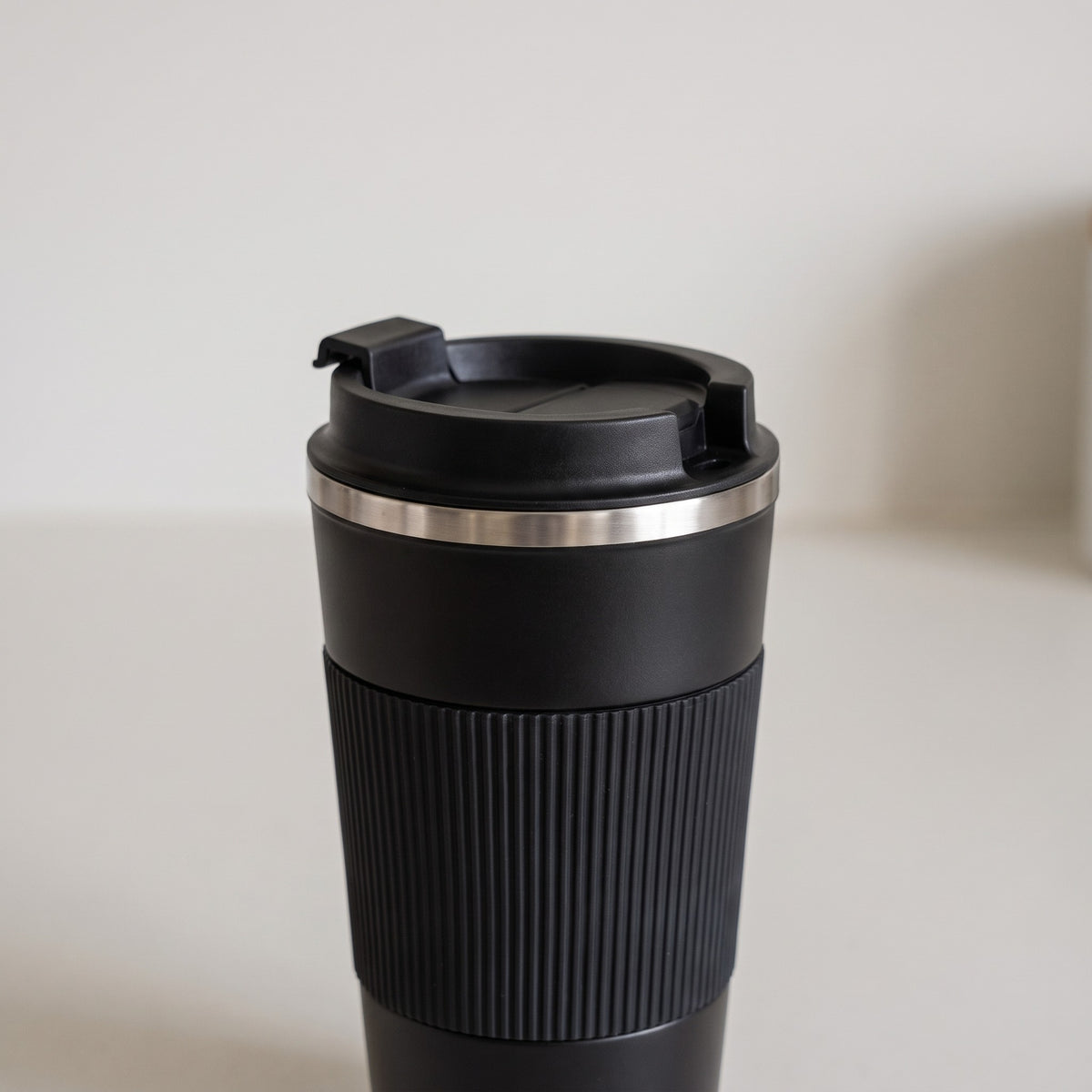 Insulated Stainless Steel Travel Mug with Flip Lid - close-up of the ribbed silicone grip band and flip lid