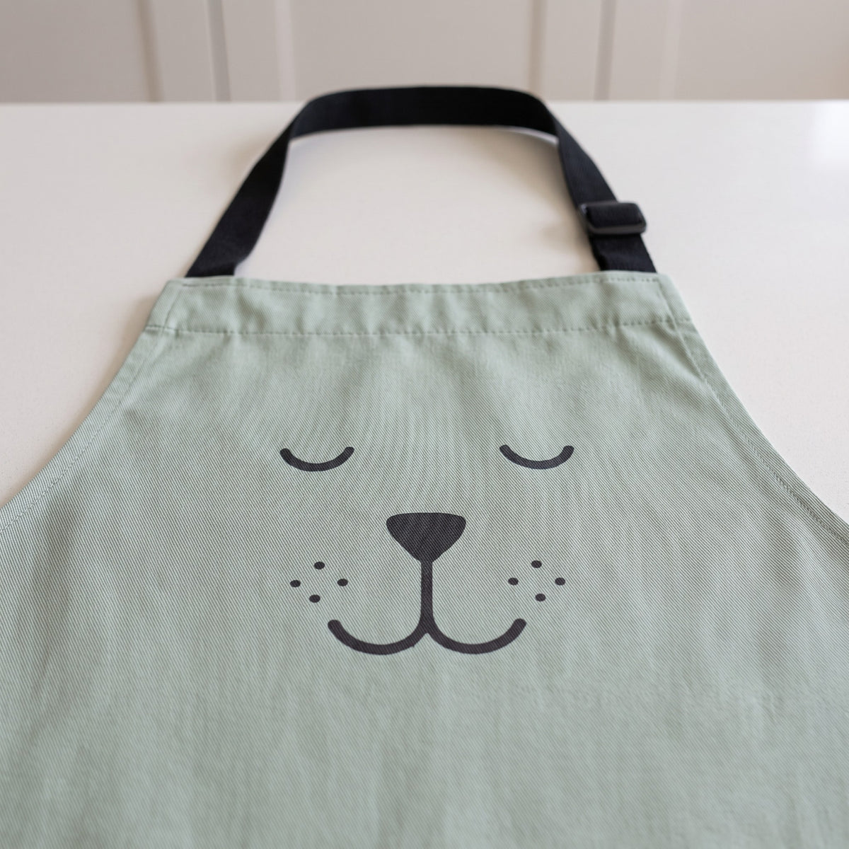 Matching Bear Motif Apron for Baking Together - close-up of the bear motif and woven fabric
