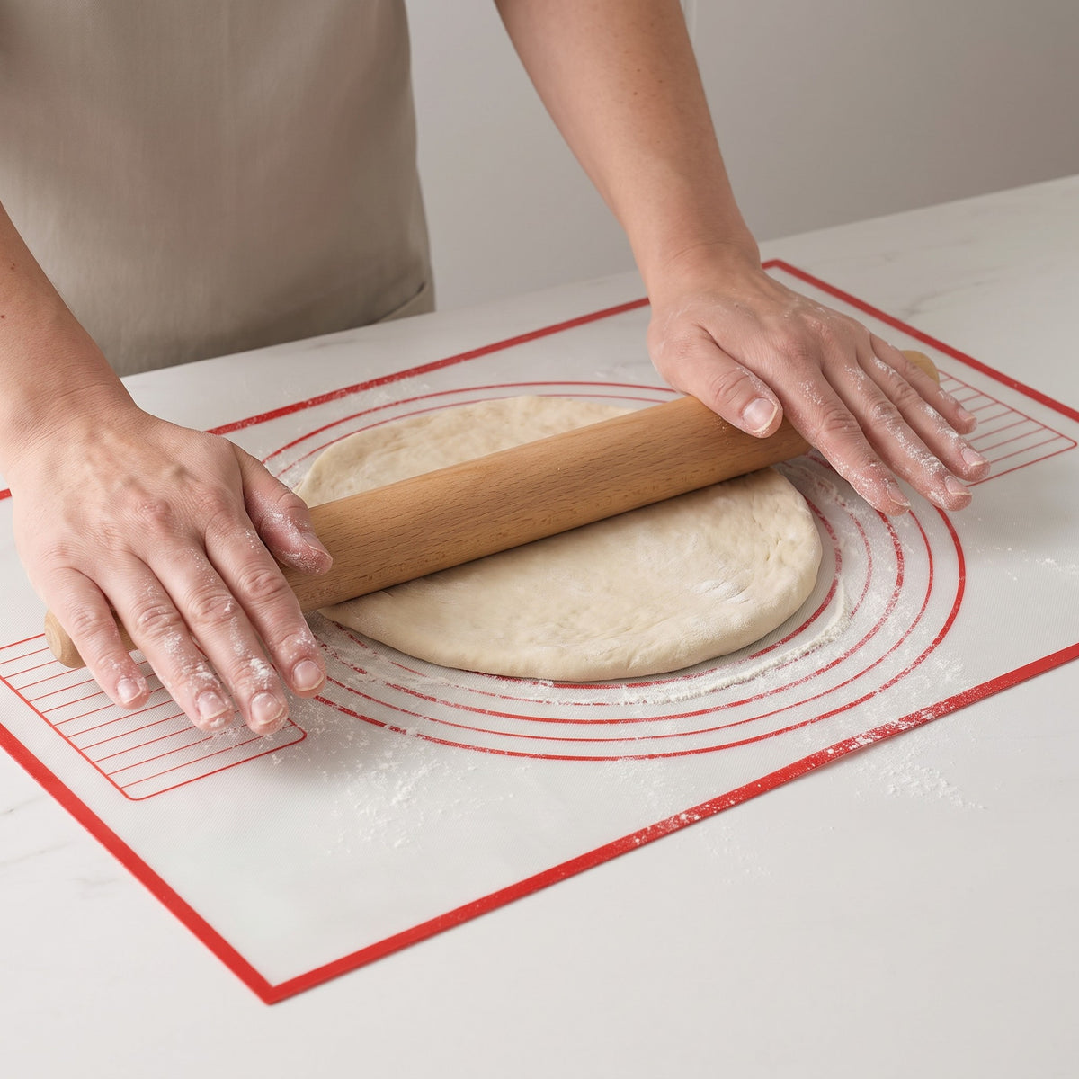 Non-Stick Silicone Pastry and Kneading Mat with Guide Circles in use, rolling out pizza dough inside the guide circles