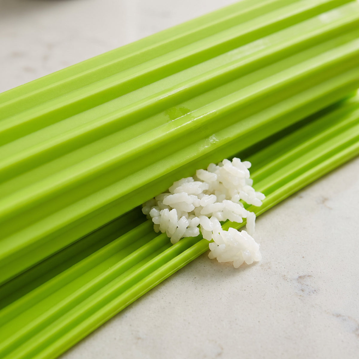 Nonstick Silicone Sushi Rolling Mat for Maki and Kimbap - close-up of the green bamboo-style silicone ridges with sushi rice