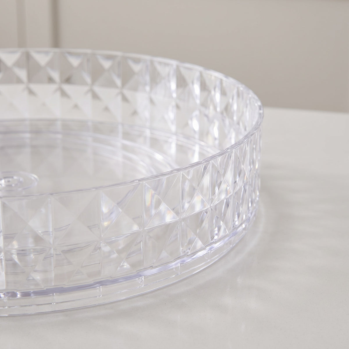 Plastic Lazy Susan Turntable Organizer with Raised Rim - close-up of the faceted clear plastic raised rim