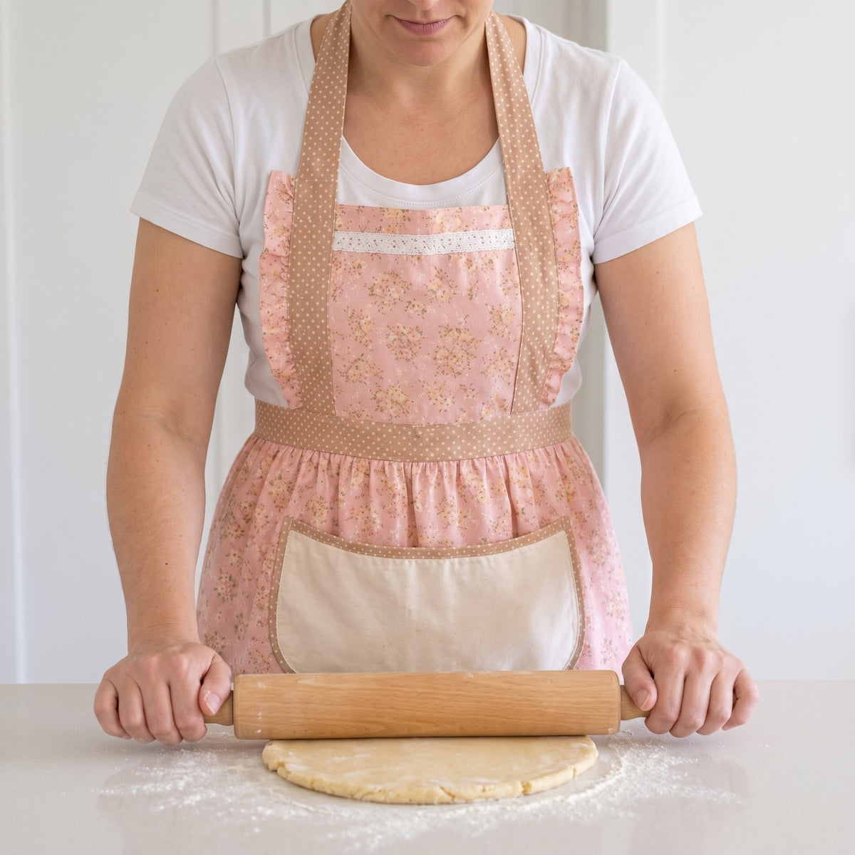 Retro Floral Ruffle Apron with Wide Shoulder Straps in use, worn while rolling out pie dough