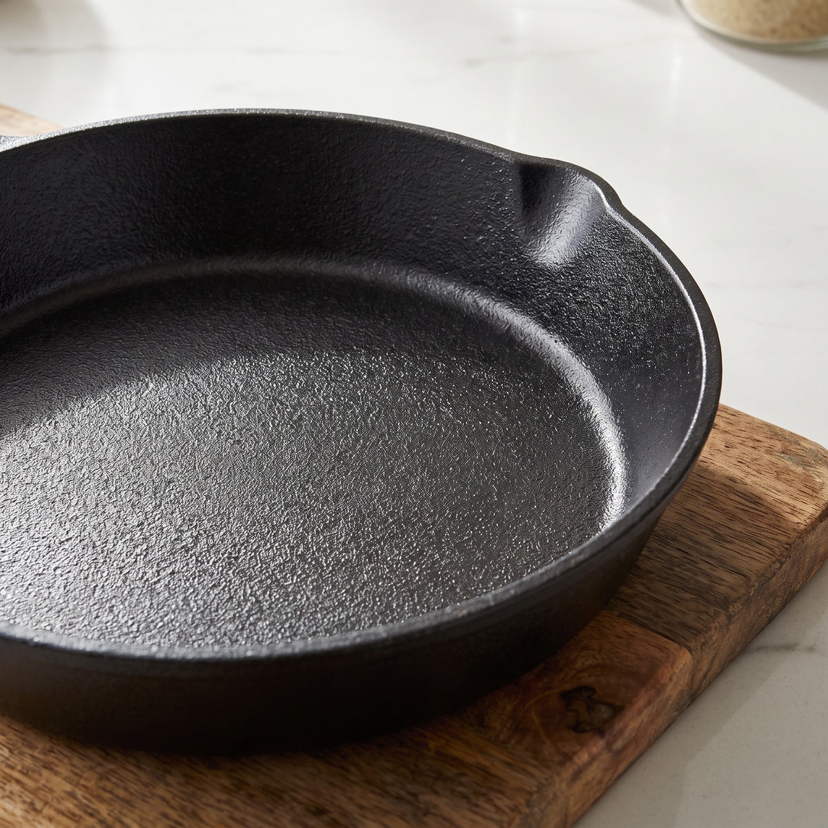 Seasoned Cast Iron Skillet with No Added Coating - close-up of the raw seasoned cast iron surface and pour spout