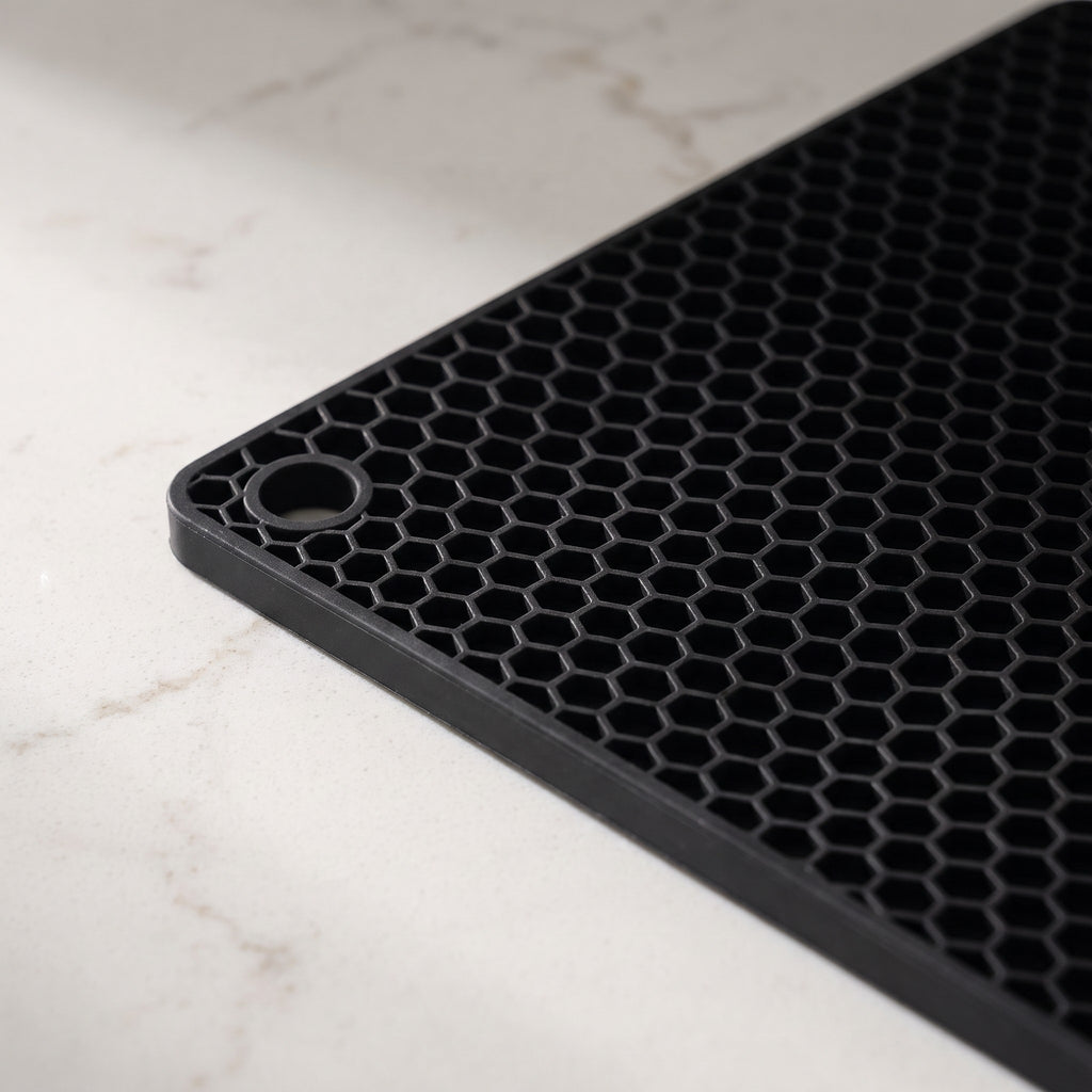 Square Silicone Trivet Mat with Honeycomb Grip - close-up of the food-grade silicone honeycomb surface and hanging hole