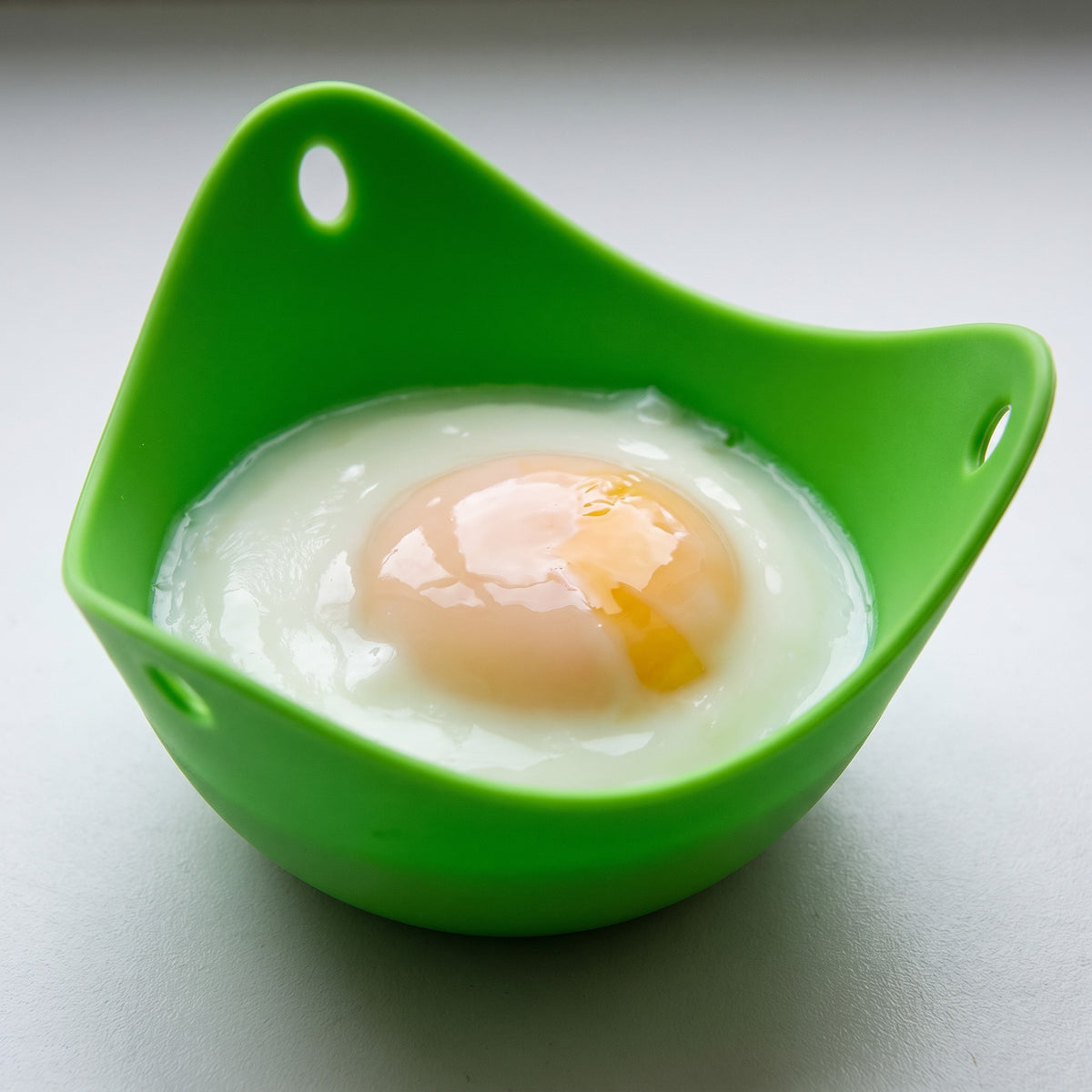 Stackable Egg Poacher Cups Set for Eggs Benedict and Brunch - close-up of a poacher cup with a neat, round poached egg