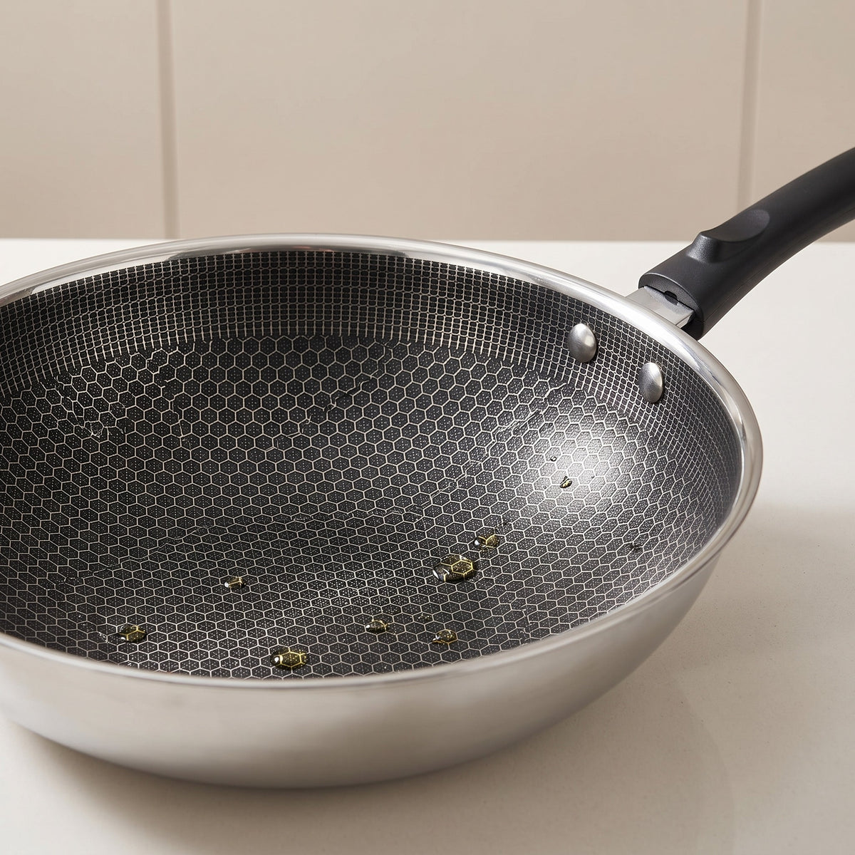 Stainless Steel Honeycomb Wok for Induction and Oven - close-up of the laser-etched honeycomb surface