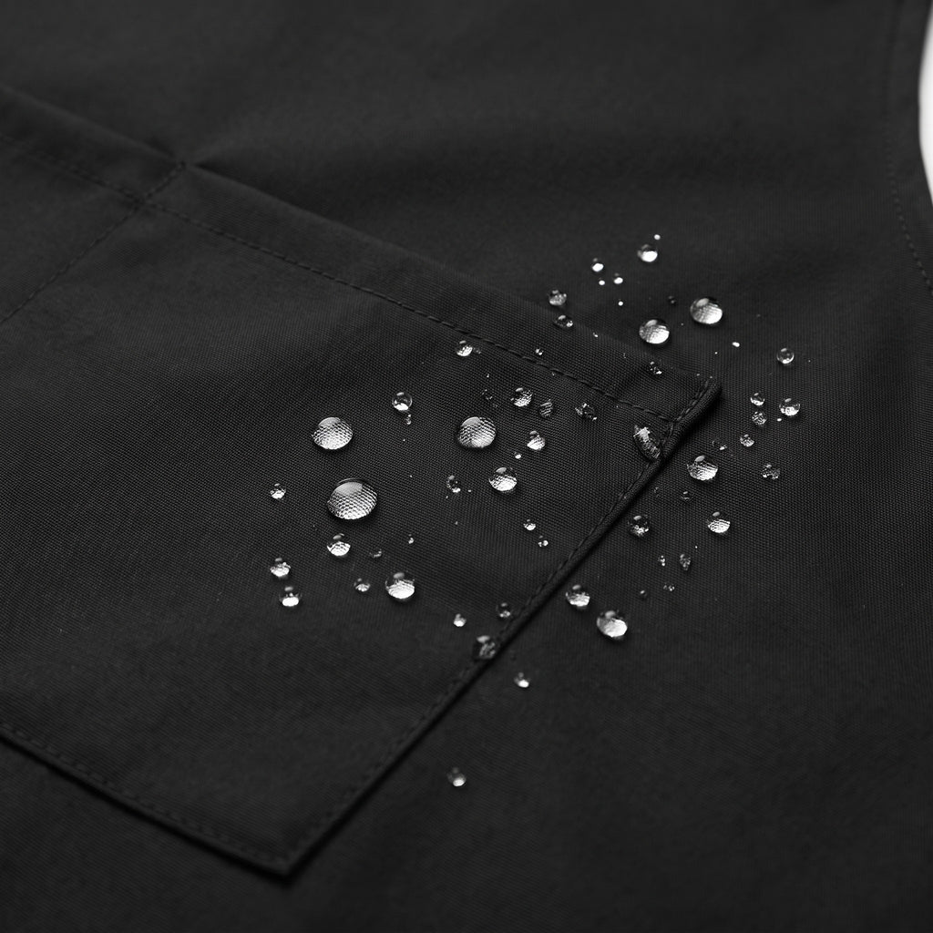 Unisex Waterproof Kitchen Apron for Cooking and Grilling - close-up of water beading on the waterproof fabric