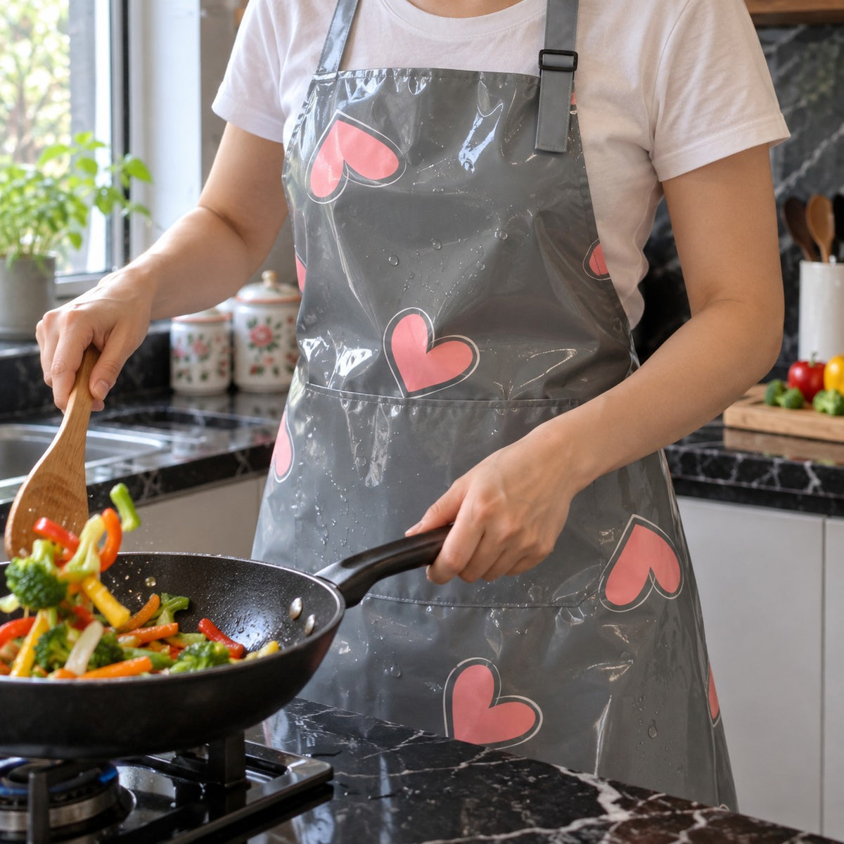 Waterproof Kitchen Apron, Heart or Daisy Print, Gray Hearts print worn in a home kitchen