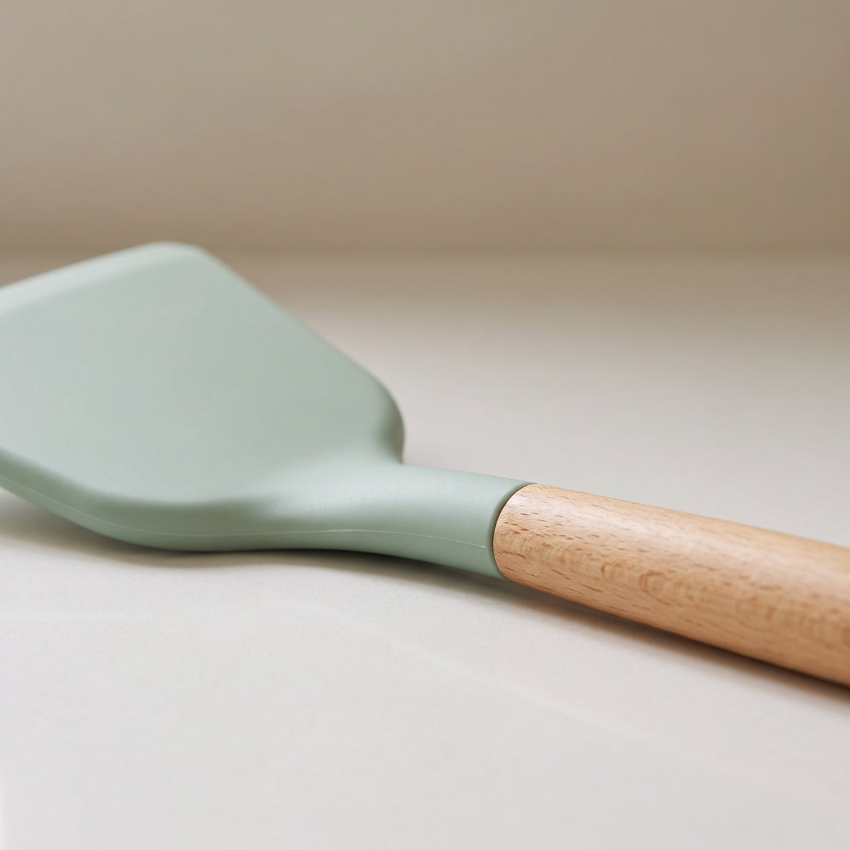 Wood-Handle Silicone Cooking Utensils for Nonstick Pans - close-up of the sage green silicone head and natural wood handle
